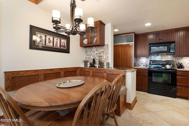 120 Offerson Rd Unit 4460, Beaver Creek, CO 81620 - kitchen with black appliances, tasteful backsplash, a chandelier, hanging light fixtures, and glass insert cabinets