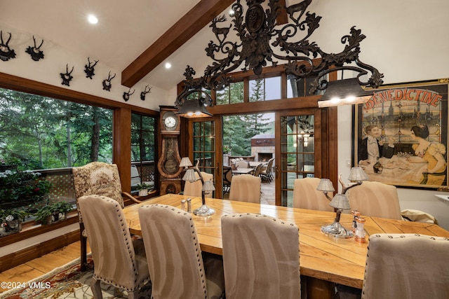 dining space with vaulted ceiling with beams and wood-type flooring