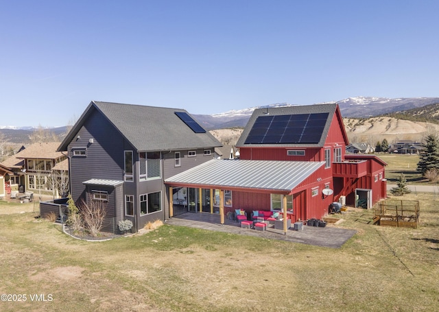 116 Thresher Ct, Eagle, CO 81631 - rear view of property featuring a mountain view, solar panels, a yard, a patio area, and metal roof