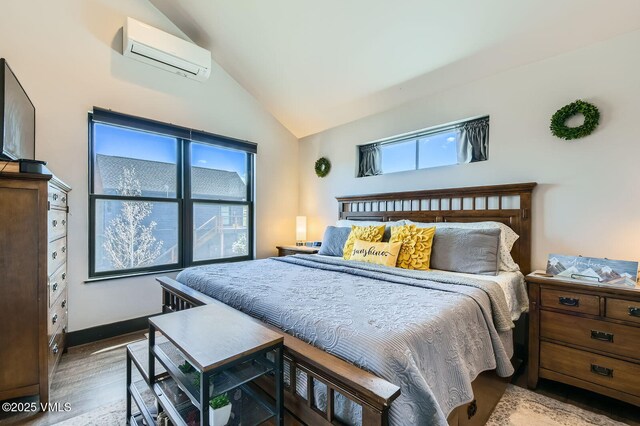 116 Thresher Ct, Eagle, CO 81631 - bedroom featuring multiple windows, lofted ceiling, wood finished floors, and a wall unit AC