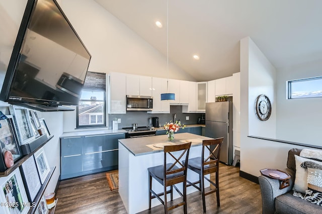 116 Thresher Ct, Eagle, CO 81631 - kitchen with a kitchen bar, white cabinetry, appliances with stainless steel finishes, a sink, and dark wood-style floors
