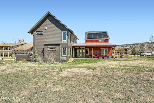 116 Thresher Ct, Eagle, CO 81631 - back of house featuring roof mounted solar panels, a yard, metal roof, a patio, and a standing seam roof