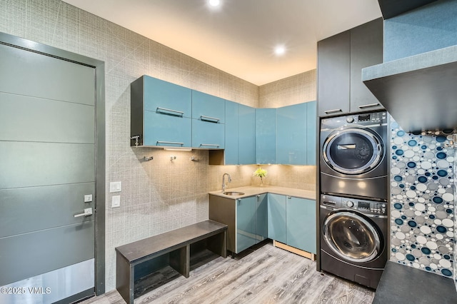 116 Thresher Ct, Eagle, CO 81631 - laundry room with light wood-style floors, laundry area, a sink, and stacked washer and clothes dryer