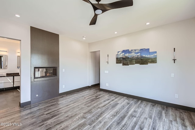 116 Thresher Ct, Eagle, CO 81631 - unfurnished living room featuring recessed lighting, a multi sided fireplace, wood finished floors, and ceiling fan