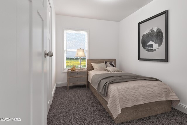 bedroom with dark colored carpet