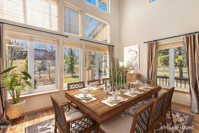 111 E Double Hitch Dr, Eagle, CO 81631 - dining room with visible vents, a high ceiling, baseboards, and wood finished floors