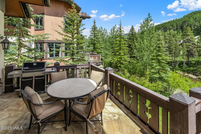 825 Forest Rd Unit 2, Vail, CO 81657 - balcony featuring outdoor dining area, a grill, and a wooded view
