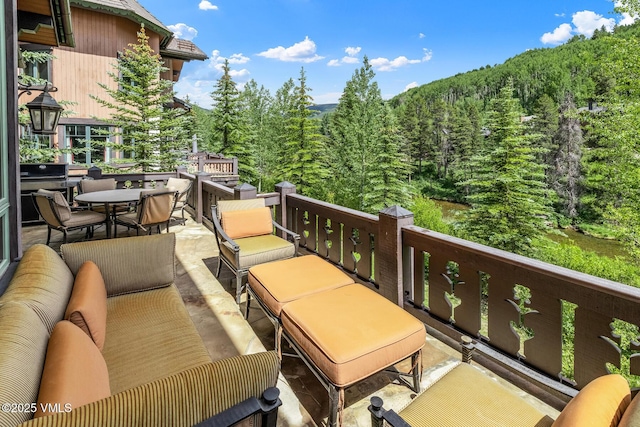 825 Forest Rd Unit 2, Vail, CO 81657 - patio / terrace featuring a wooded view, an outdoor hangout area, and outdoor dining space