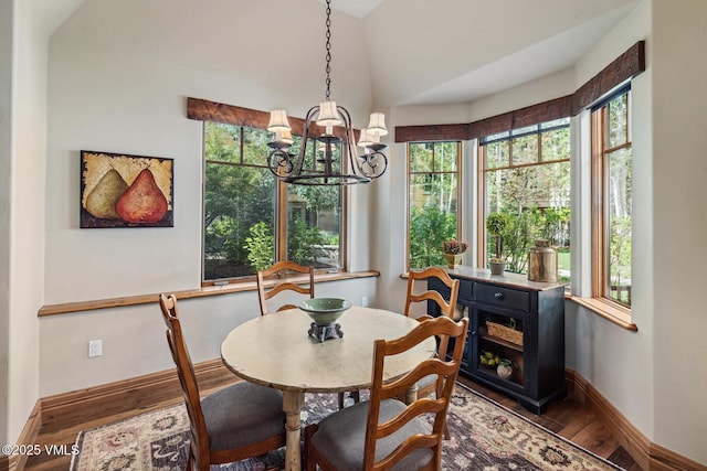 825 Forest Rd Unit 2, Vail, CO 81657 - dining space with wood finished floors, a chandelier, vaulted ceiling, and plenty of natural light