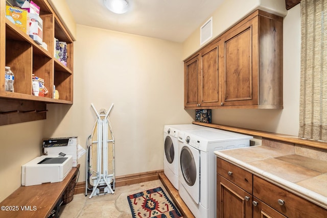 825 Forest Rd Unit 2, Vail, CO 81657 - laundry area featuring independent washer and dryer and cabinet space