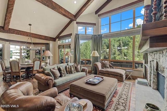 825 Forest Rd Unit 2, Vail, CO 81657 - living room with high vaulted ceiling, beam ceiling, a stone fireplace, and wood finished floors