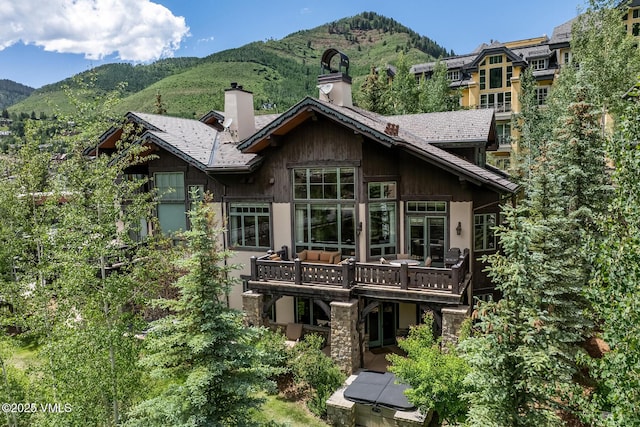 825 Forest Rd Unit 2, Vail, CO 81657 - back of house featuring a chimney and a deck with mountain view