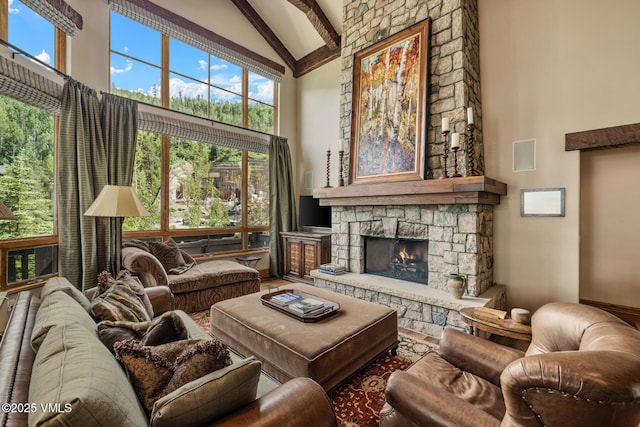 825 Forest Rd Unit 2, Vail, CO 81657 - living room featuring high vaulted ceiling, beamed ceiling, a stone fireplace, and wood finished floors