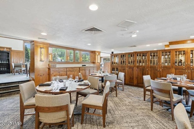 120 Offerson Unit 3430, Beaver Creek, CO 81620 - dining space featuring recessed lighting, light colored carpet, a textured ceiling, and wooden walls