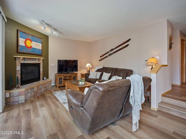 10000 Ryan Gulch Rd Unit 114, Silverthorne, CO 80498 - living area featuring wood finished floors, a fireplace, and track lighting