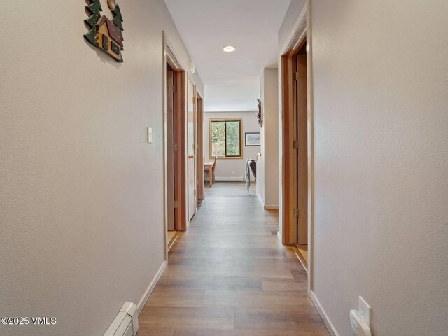 10000 Ryan Gulch Rd Unit 114, Silverthorne, CO 80498 - corridor with wood finished floors, recessed lighting, and a baseboard heating unit