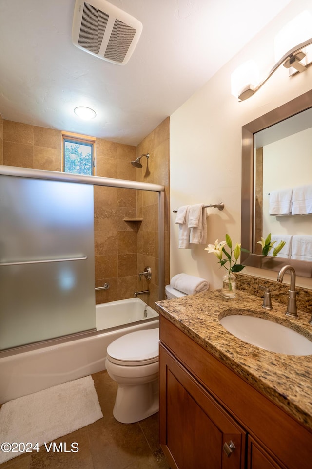 full bath with visible vents, bath / shower combo with glass door, toilet, tile patterned flooring, and vanity