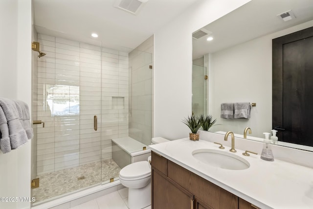 bathroom featuring visible vents, toilet, and a shower stall