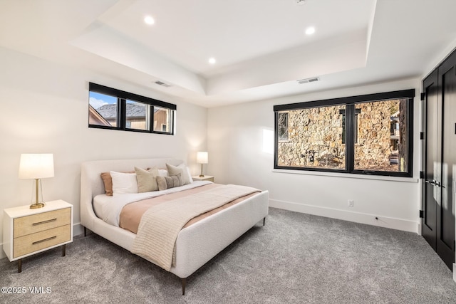 carpeted bedroom with visible vents, recessed lighting, baseboards, and a tray ceiling