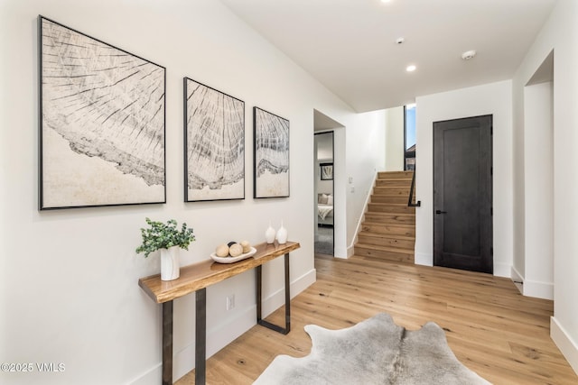 foyer entrance with stairs, recessed lighting, wood finished floors, and baseboards