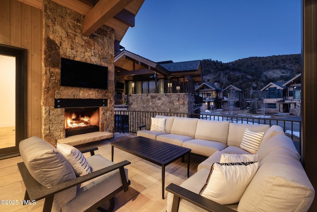 view of patio with an outdoor living space with a fireplace