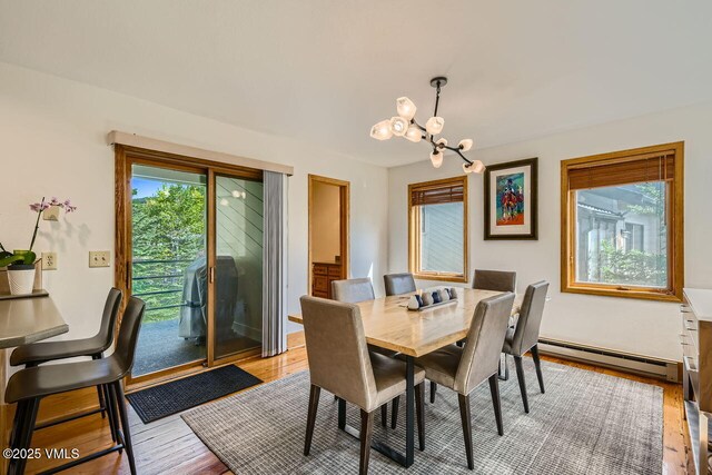 3050 Wildridge Rd Unit 3, Avon, CO 81620 - dining area with baseboard heating, a chandelier, and light wood-style flooring