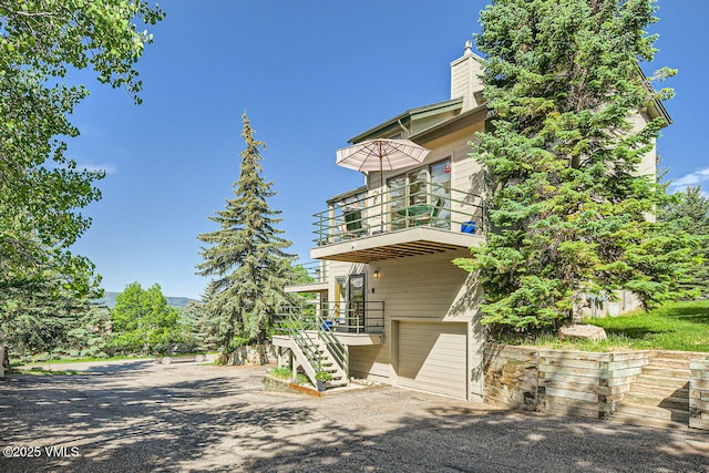 3050 Wildridge Rd Unit 3, Avon, CO 81620 - view of property with an attached garage, stairway, and driveway