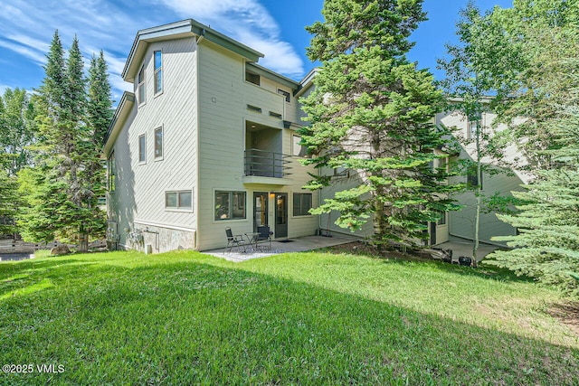 3050 Wildridge Rd Unit 3, Avon, CO 81620 - back of property with a balcony, a patio, and a lawn