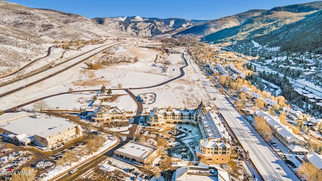 snowy aerial view with a mountain view