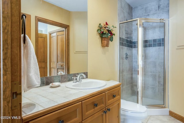 bathroom featuring an enclosed shower, vanity, tile patterned flooring, and toilet