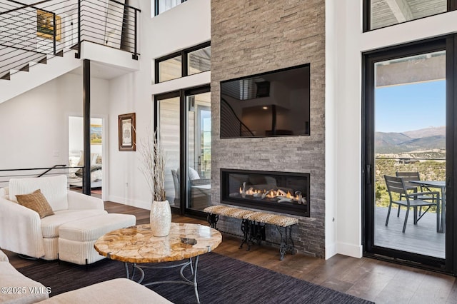 2296 E Haystacker Dr, Eagle, CO 81631 - living room featuring plenty of natural light, wood finished floors, baseboards, and a towering ceiling