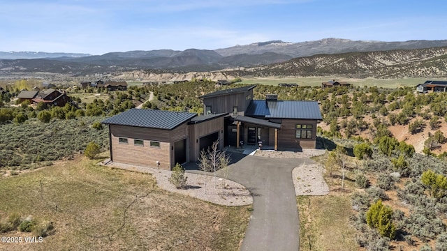 2296 E Haystacker Dr, Eagle, CO 81631 - view of front of home with a garage, a mountain view, driveway, and metal roof