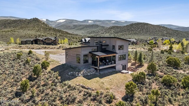 2296 E Haystacker Dr, Eagle, CO 81631 - back of property with a deck with mountain view and board and batten siding
