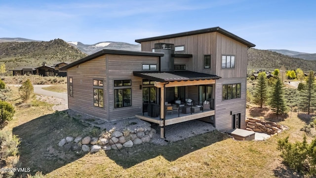 2296 E Haystacker Dr, Eagle, CO 81631 - back of property featuring a standing seam roof, a deck with mountain view, and metal roof