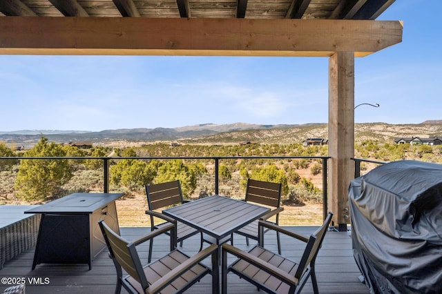 2296 E Haystacker Dr, Eagle, CO 81631 - wooden deck with a mountain view, outdoor dining space, and grilling area