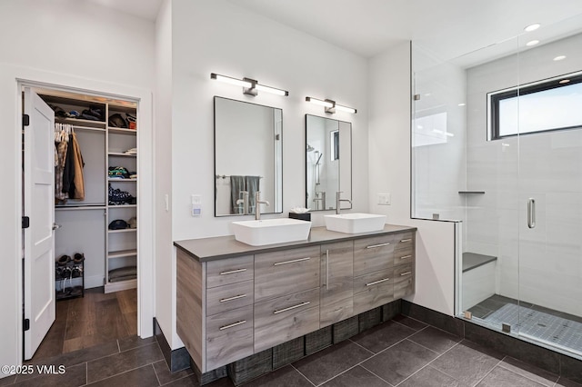 2296 E Haystacker Dr, Eagle, CO 81631 - bathroom with a stall shower, double vanity, a spacious closet, recessed lighting, and baseboards