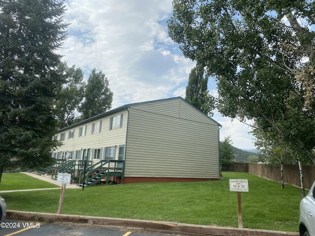 view of side of home featuring a lawn