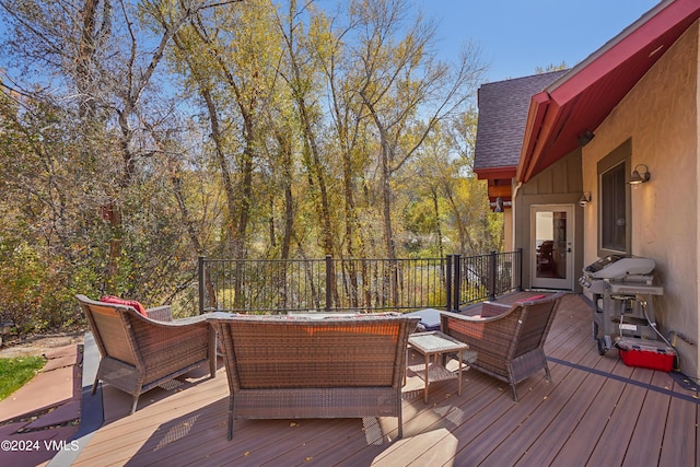 deck with grilling area and an outdoor living space