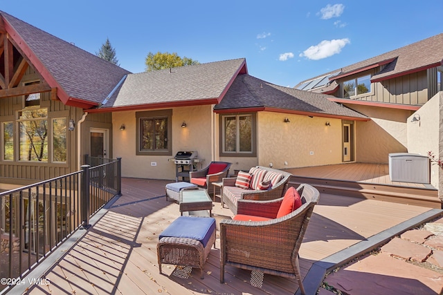 wooden deck featuring grilling area and an outdoor living space