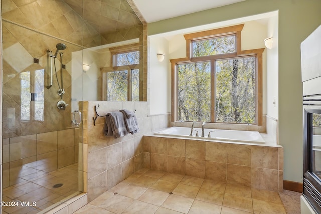 full bathroom with a stall shower, plenty of natural light, a garden tub, and tile patterned floors