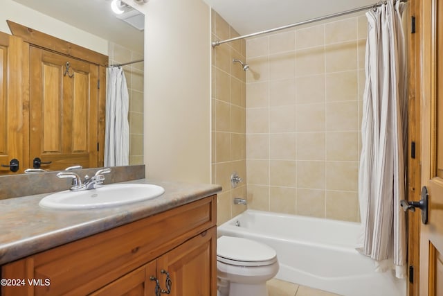 full bathroom with toilet, shower / bath combo with shower curtain, vanity, and tile patterned floors