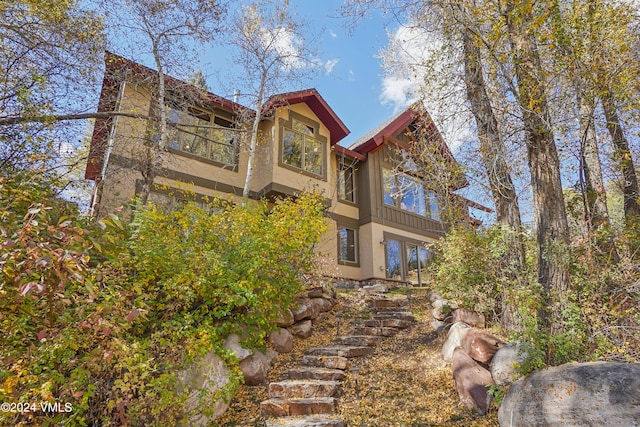 view of home's exterior featuring a balcony and stucco siding