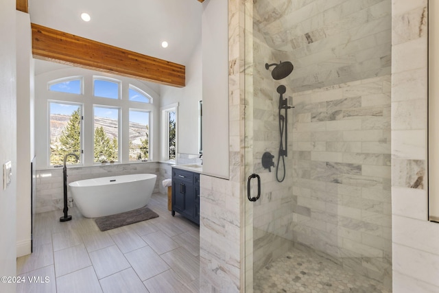 bathroom featuring vanity, vaulted ceiling with beams, and separate shower and tub