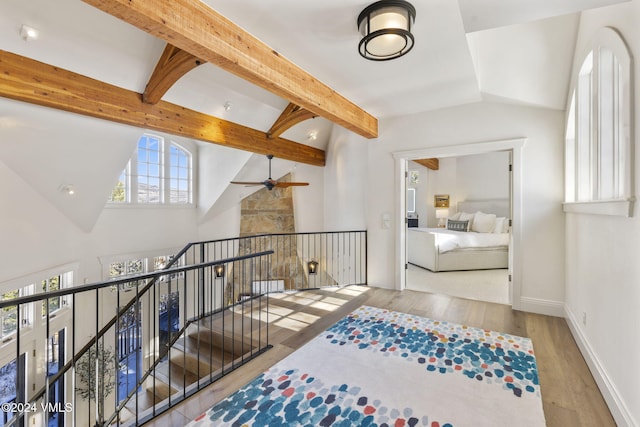 hallway with hardwood / wood-style floors, high vaulted ceiling, and beamed ceiling