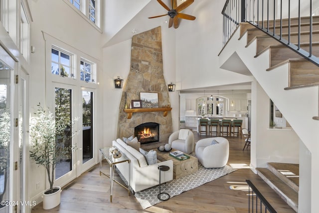 living room featuring plenty of natural light, a fireplace, and light hardwood / wood-style flooring