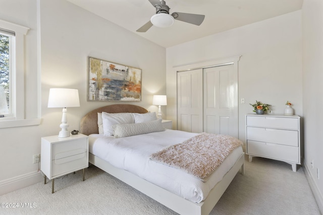 carpeted bedroom featuring a closet and ceiling fan