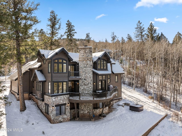 view of snow covered back of property