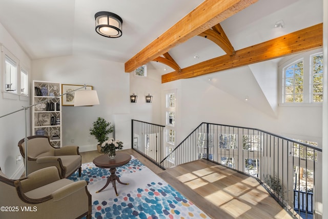 living room with beamed ceiling and high vaulted ceiling