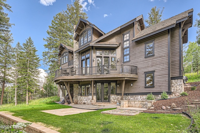 rear view of property with french doors, a yard, a deck, and a patio area