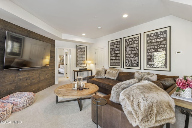 living room with carpet and wooden walls